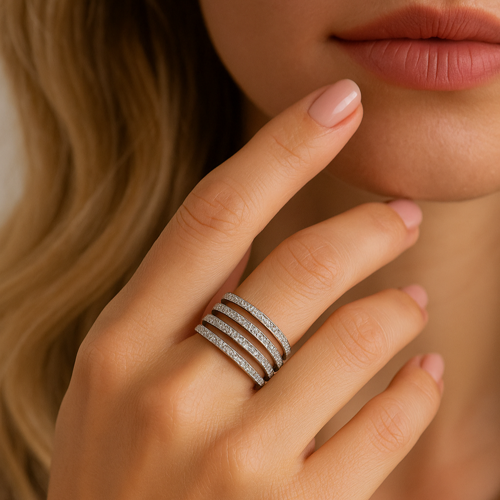 Close-up of a hand wearing multiple diamond rings with a blurred background