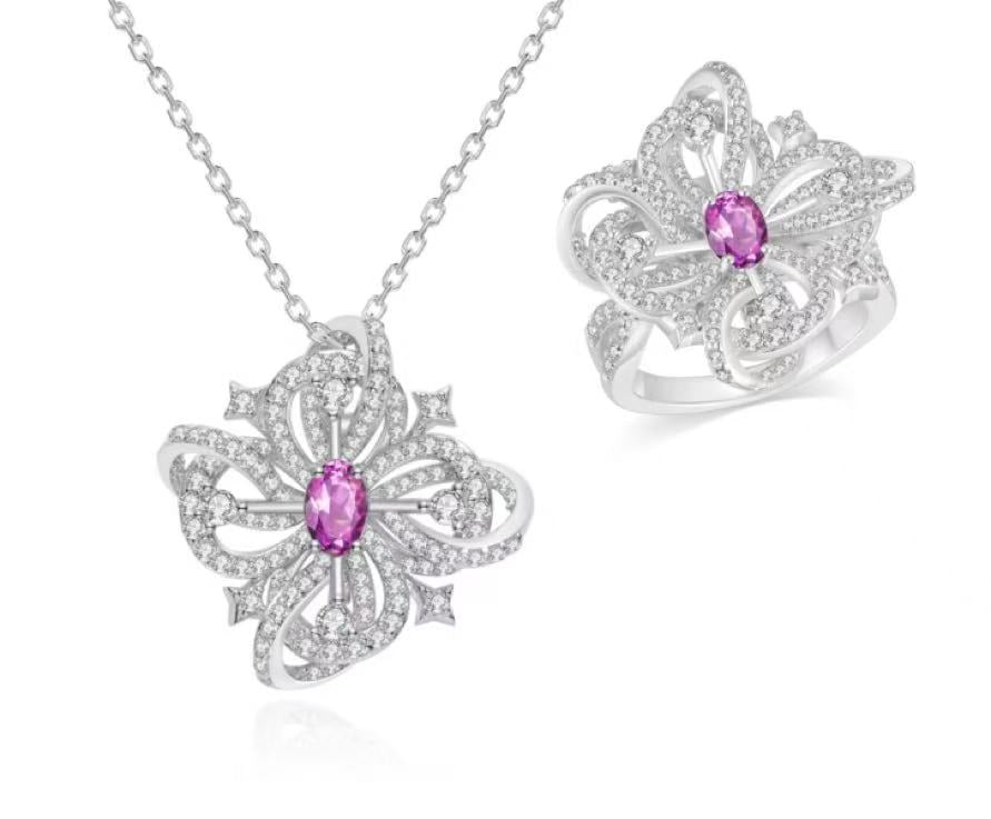 Butterfly-shaped jewelry set with pink gemstones on a white background