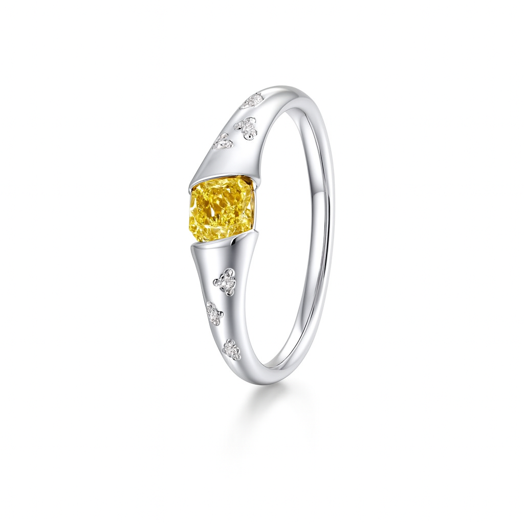 Silver ring with a yellow gemstone on a white background