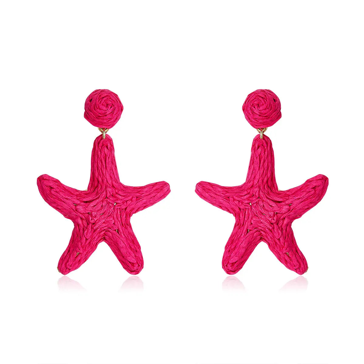 Bright hot pink starfish-shaped earrings made from woven fibers, called Coral Star Drops.
