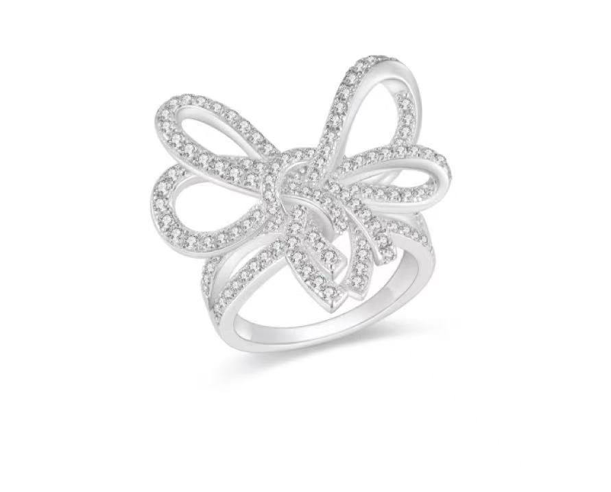 Silver butterfly ring with clear stones on a white background