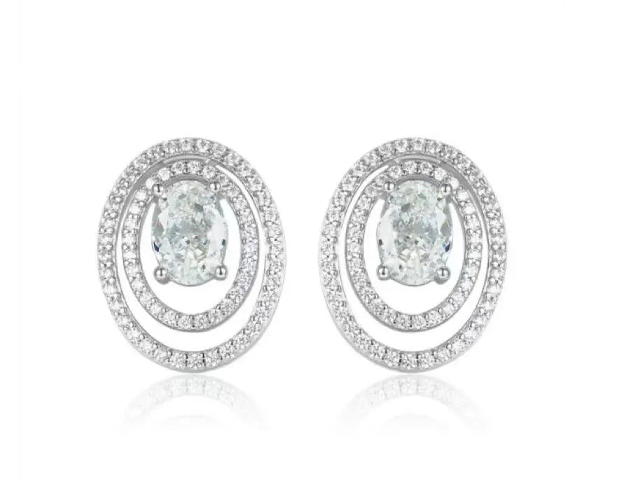 Pair of silver earrings with green gemstones on a white background