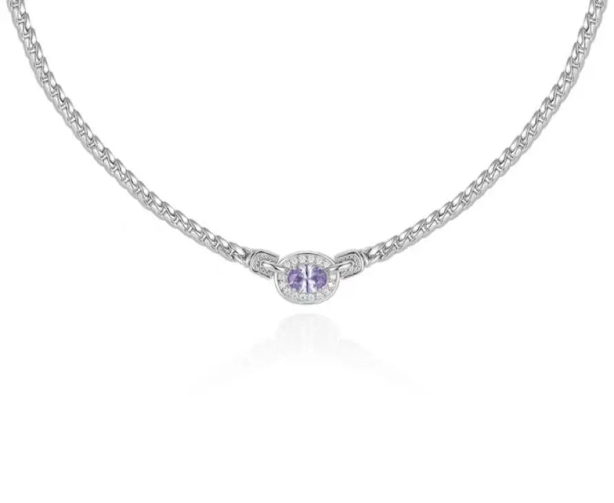 Silver necklace with a round pendant on a white background