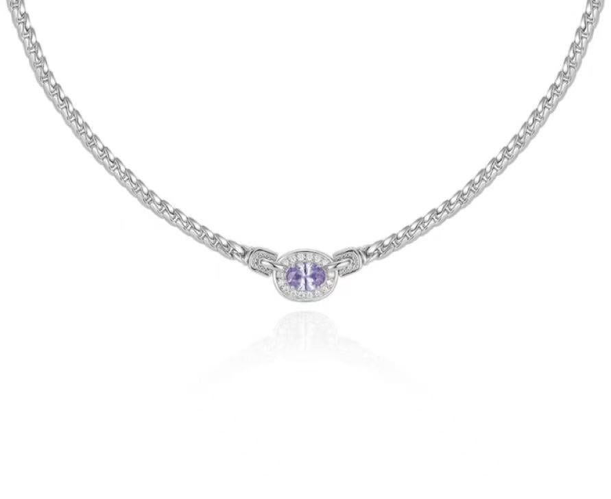 Silver necklace with a round pendant on a white background