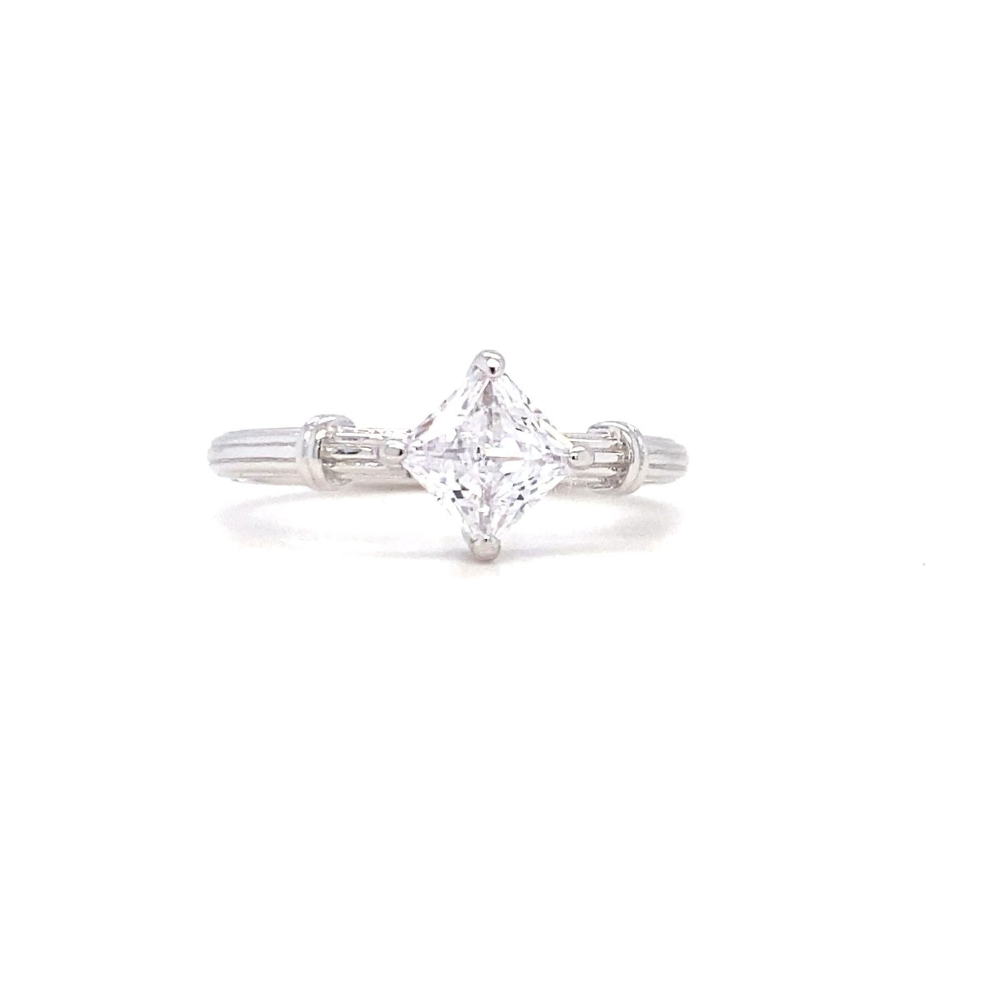 Diamond ring with a triangular stone on a white background