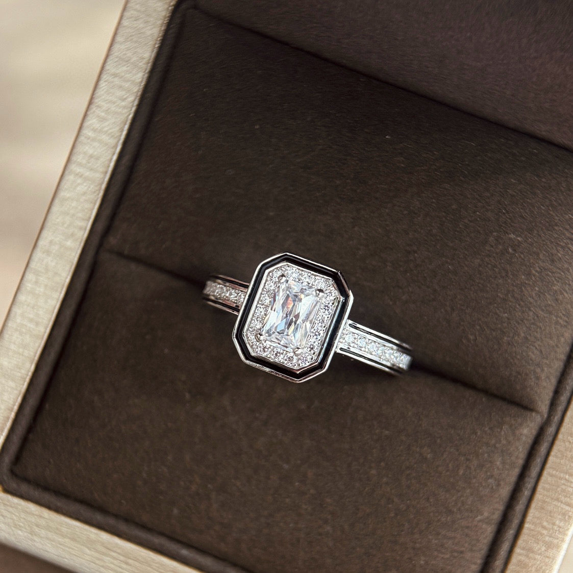 Diamond ring in a brown jewelry box