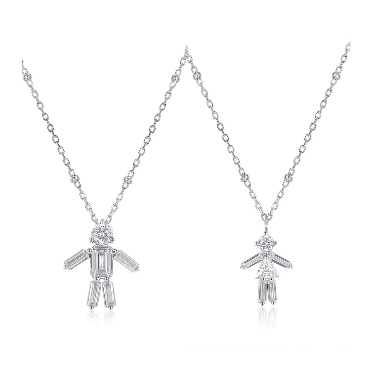 Two silver pendants on chains against a white background