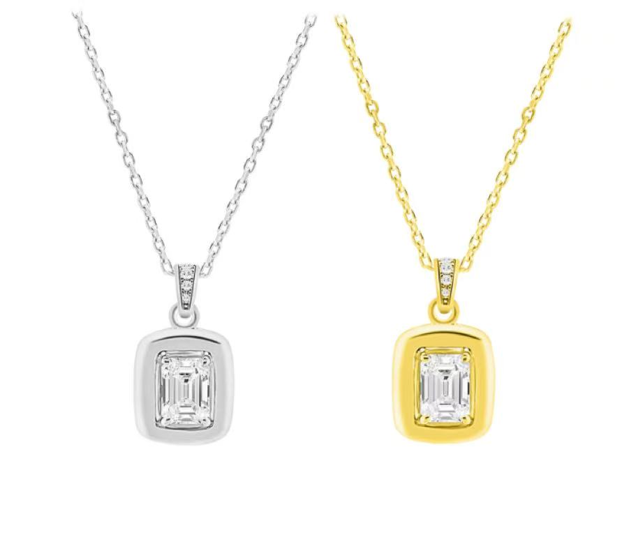 Two diamond pendants, one silver and one gold, on white background