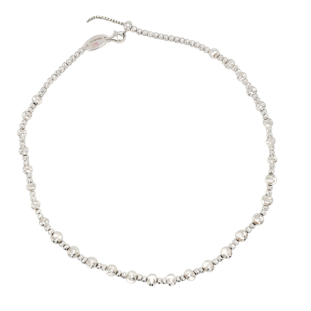 Silver beaded necklace on a white background