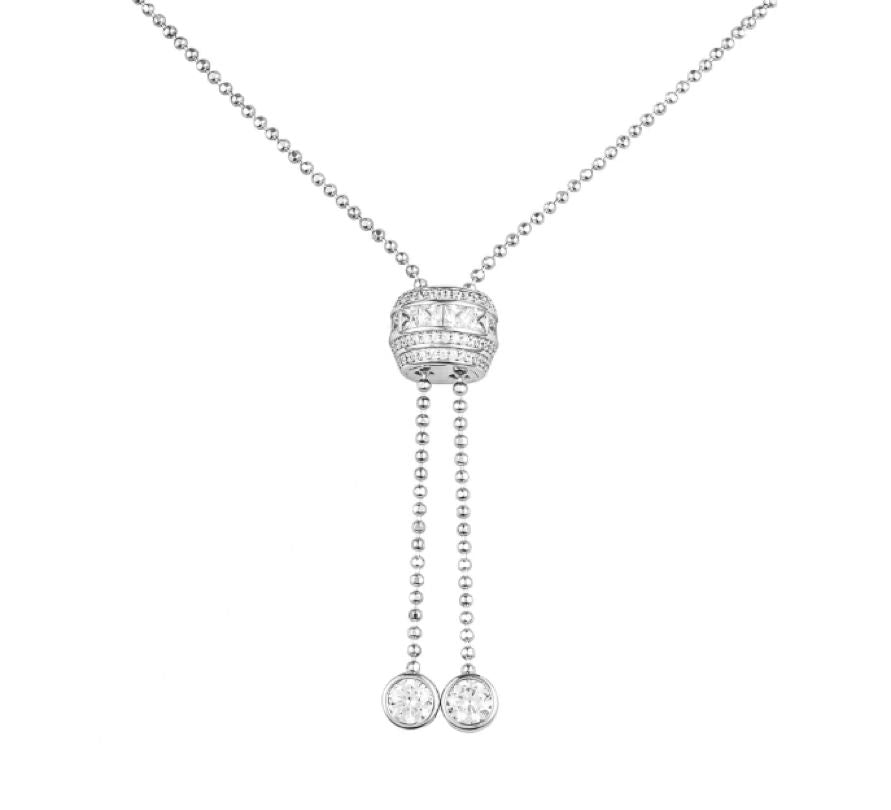 Silver necklace with a pendant and two hanging charms on a white background