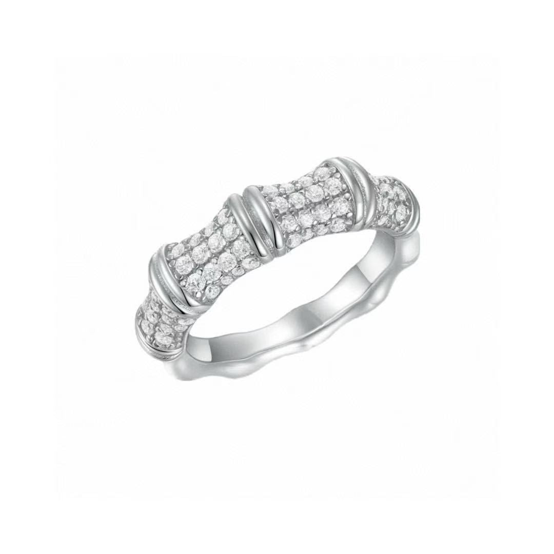 Silver ring with diamond accents on a white background
