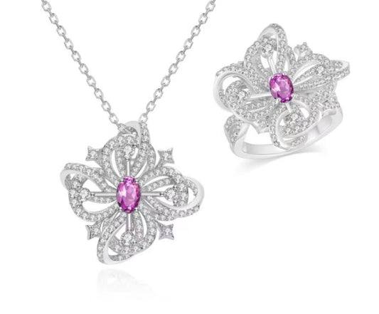 Butterfly-shaped jewelry set with pink gemstones on a white background