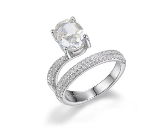 Silver ring with a large central gemstone and smaller stones on a white background