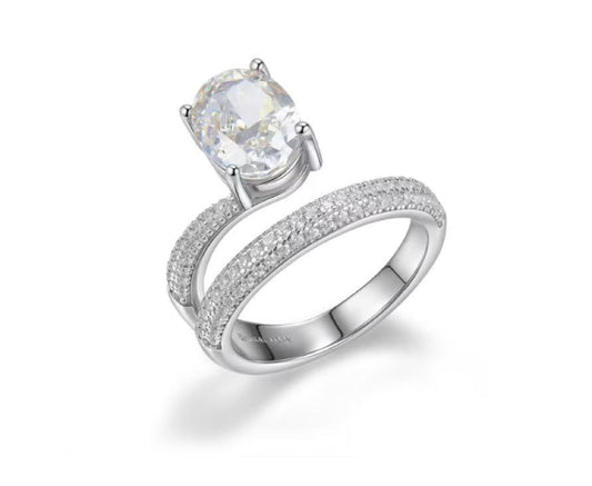 Silver ring with a large central gemstone and smaller stones on a white background