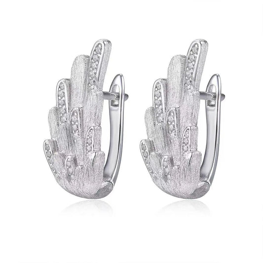 Silver hamsa hand earrings on a white background
