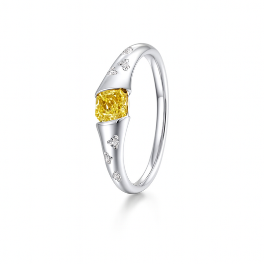 Silver ring with a yellow gemstone on a white background