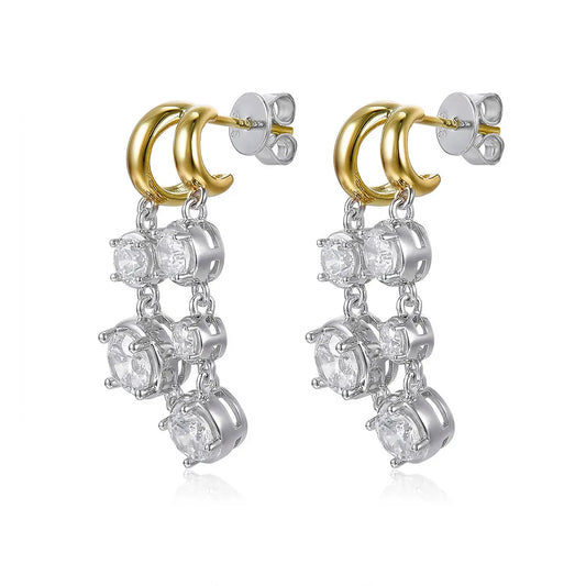 Pair of earrings with gold and silver loops on a white background
