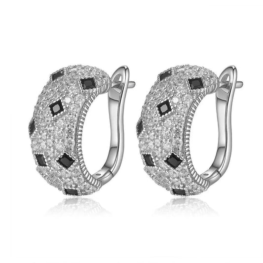 Silver hoop earrings with black and clear gemstones on a white background