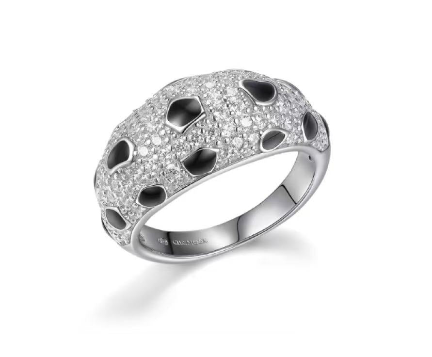 Silver ring with black stones on a white background