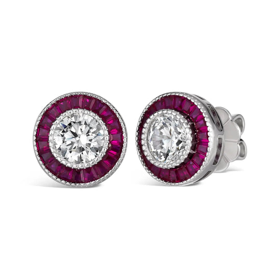 Pair of earrings with round gemstones and purple gemstone accents on a white background