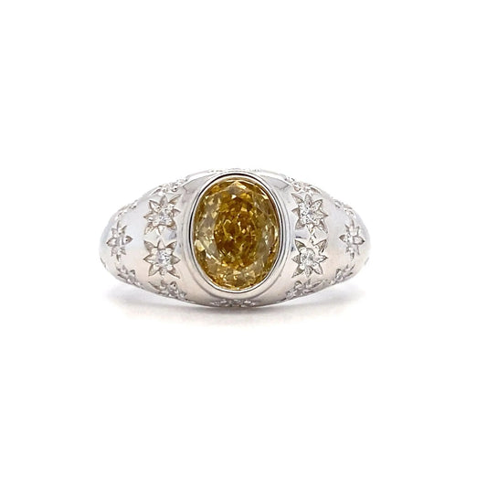 Silver ring with a yellow gemstone on a white background