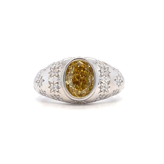 Silver ring with a yellow gemstone on a white background