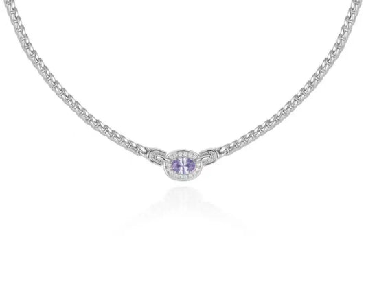 Silver necklace with a round pendant on a white background