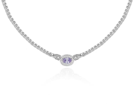 Silver necklace with a round pendant on a white background