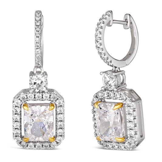 Anna Zuckerman Harper Radiant Huggies in White Diamond feature radiant-cut white diamonds with a crystalline halo in sterling silver. Elegant 1-inch huggie earrings with gold prong accents, perfect for luxury jewelry collections.