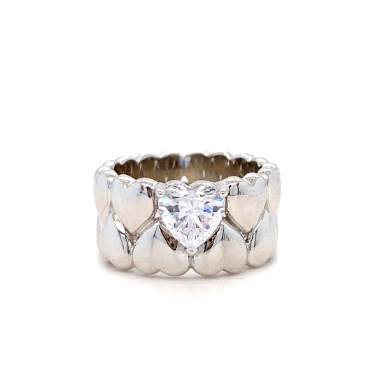 Silver ring with heart-shaped diamond on a white background