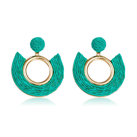 Teal half-moon woven earrings with central gold ring.