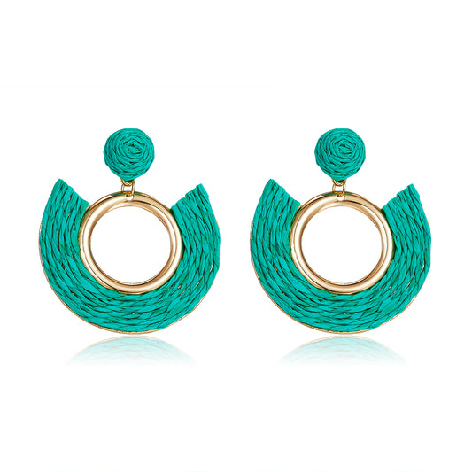 Teal half-moon woven earrings with central gold ring.