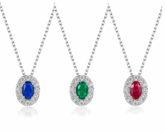 Three necklaces with gemstone pendants on a white background