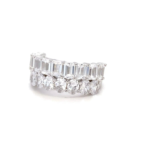 Diamond ring with emerald-cut and round diamonds on a white background