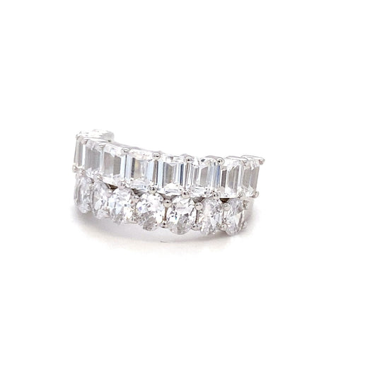 Diamond ring with emerald-cut and round diamonds on a white background