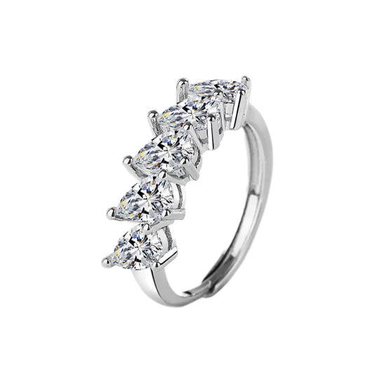 Silver ring with multiple diamonds on a white background