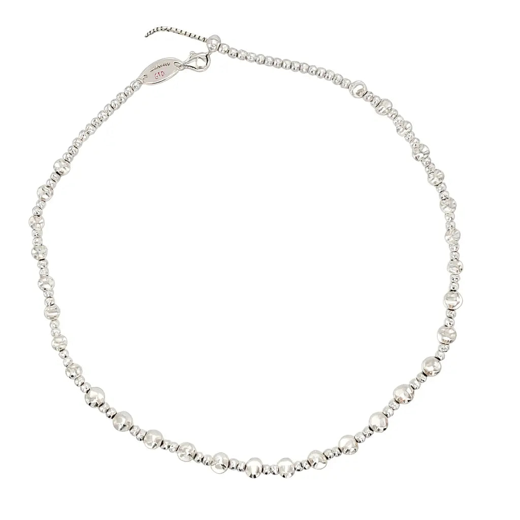 Silver beaded necklace on a white background