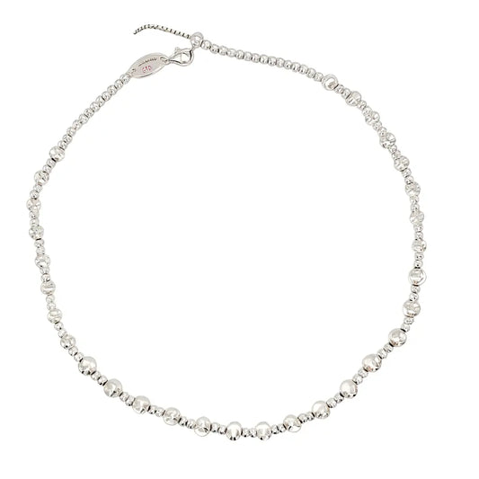 Silver beaded necklace on a white background