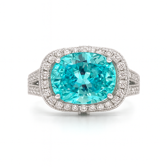 Ring with a large turquoise gemstone and diamond-studded band on a white background