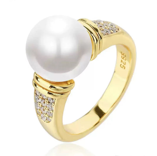 Gold ring with a pearl and small diamonds on a white background