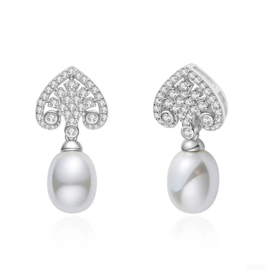 Pair of pearl earrings with diamond-like stones on a white background