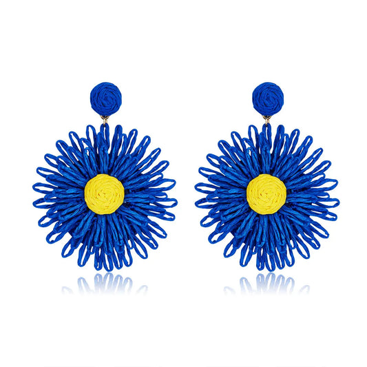 Sapphire blue woven flower earrings with a bright yellow center, named Sapphire Sunshine Blooms.