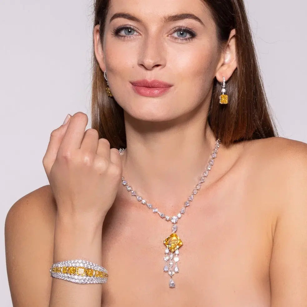 Model wearing Anna Zuckerman Sonata 10 Carat Crystalline Drops, featuring emerald cut canary yellow stones in platinum-finished sterling silver settings.