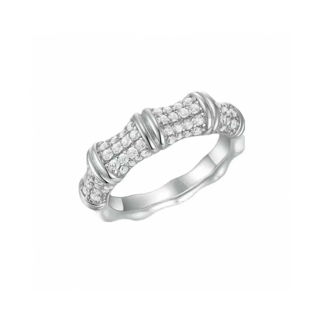 Silver ring with diamond accents on a white background