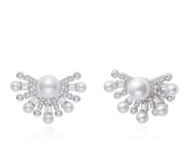 Pearl earrings with silver accents on a white background