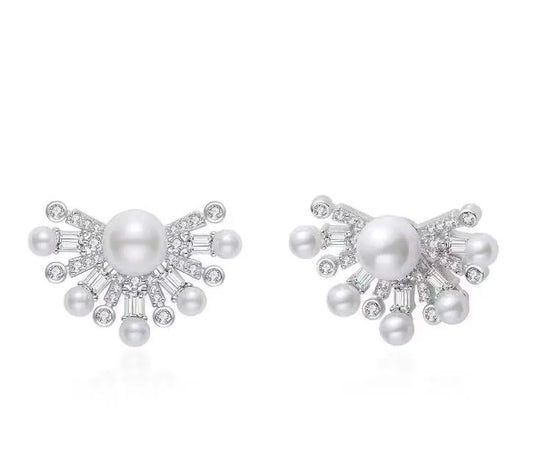 Pearl earrings with silver accents on a white background