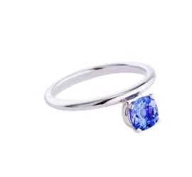 Silver ring with a blue gemstone on a white background
