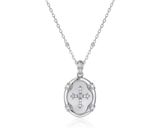 Silver necklace with a pendant featuring a cross design on a white background