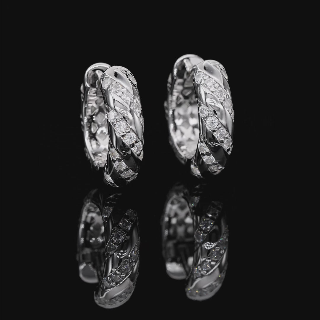 Pair of silver hoop earrings with diamond accents on a white background