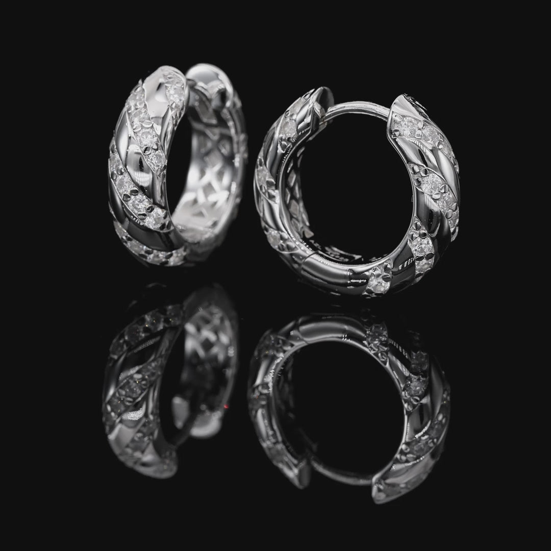 Pair of silver hoop earrings with diamond accents on a white background